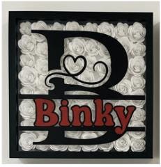 Black Shadowbox with initial and name surrounded by colorful hand rolled flowers